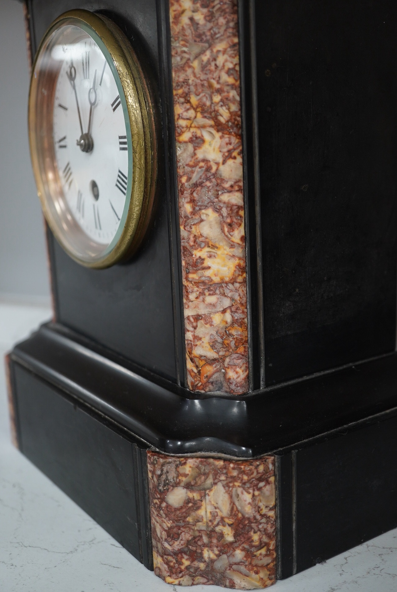 A slate mantel clock and a miniature bracket timepiece, slate clock 25cm high. Condition - miniature bracket time piece, polish on top worn,slate clock has fine scratch.